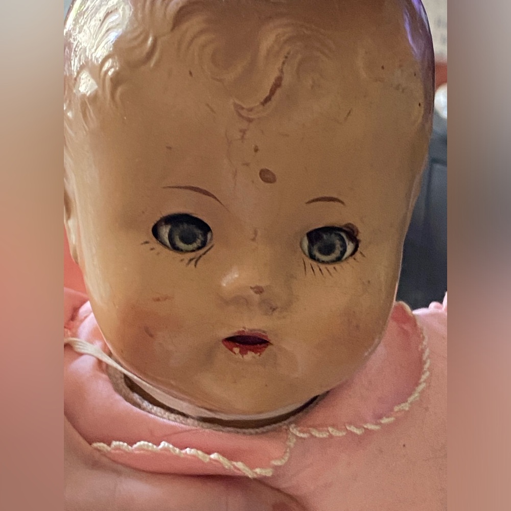 Vintage Composition babydoll 18” long. She is beautifully dressed in pink.